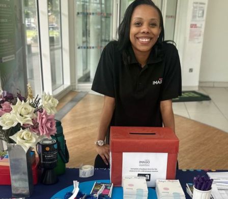 Young female carer serving up a spaghetti dinner  